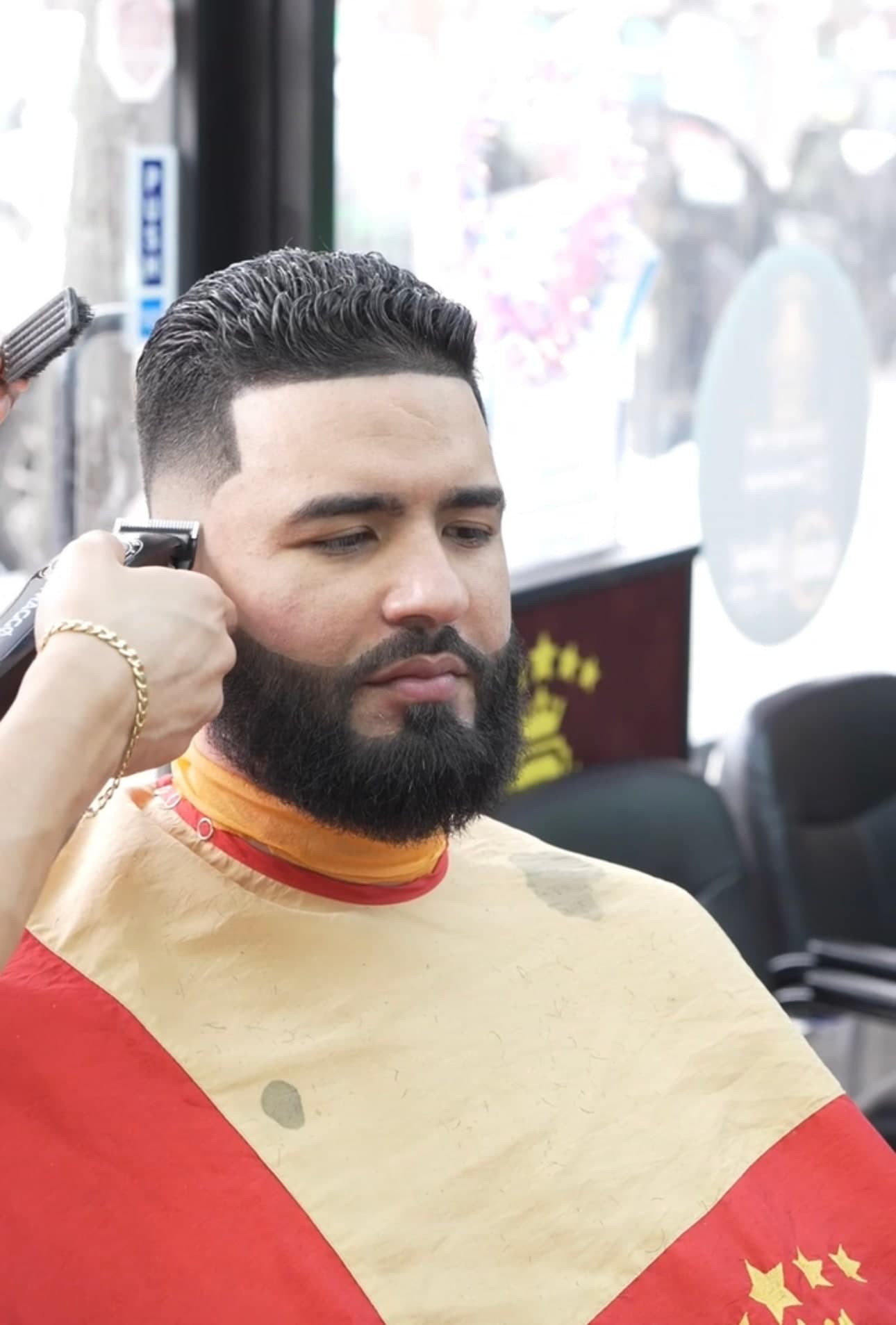 Sharp skin fade with beard lineup at Traggocuts