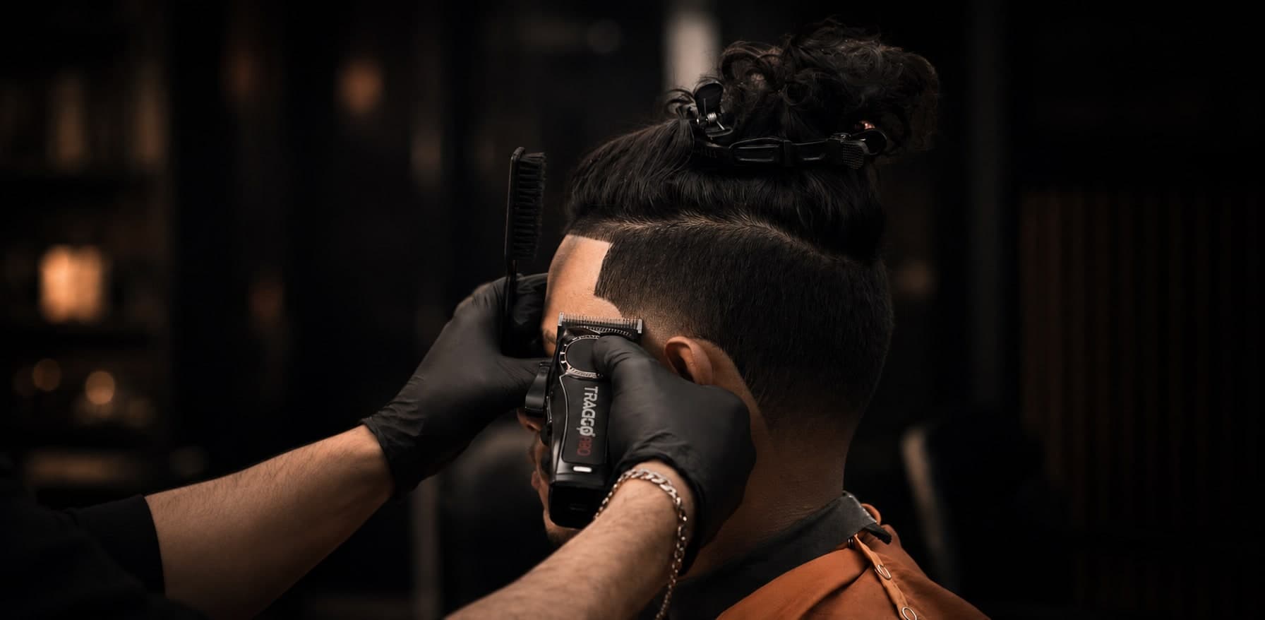 Felix Urban, licensed barber, working on a client's fade at TRAGGOCUTS in Ridgewood, NY